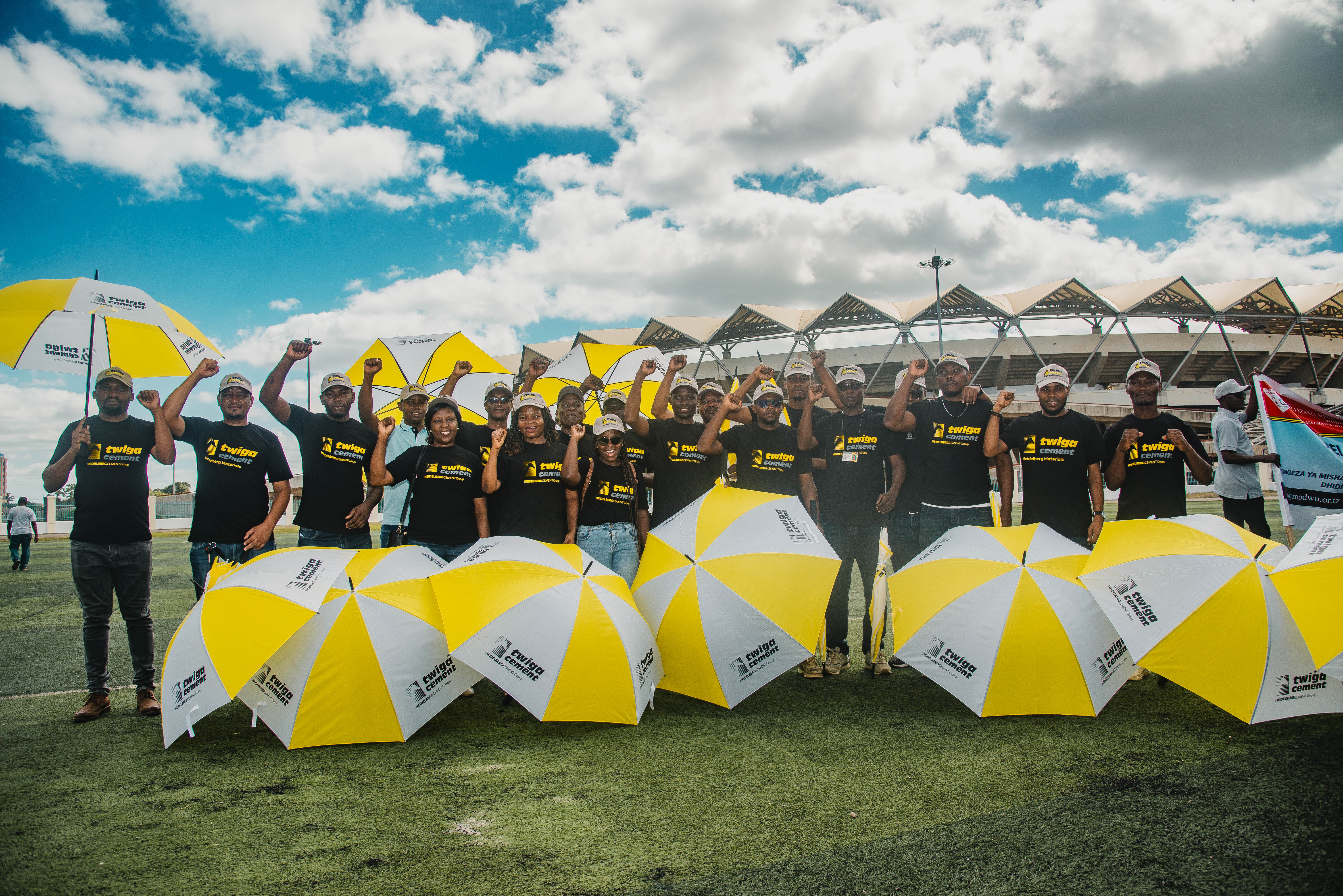 Group of people with yellow and white umbrellas